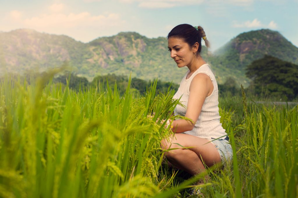 Woman in a field in an ag land in Kailua Kona