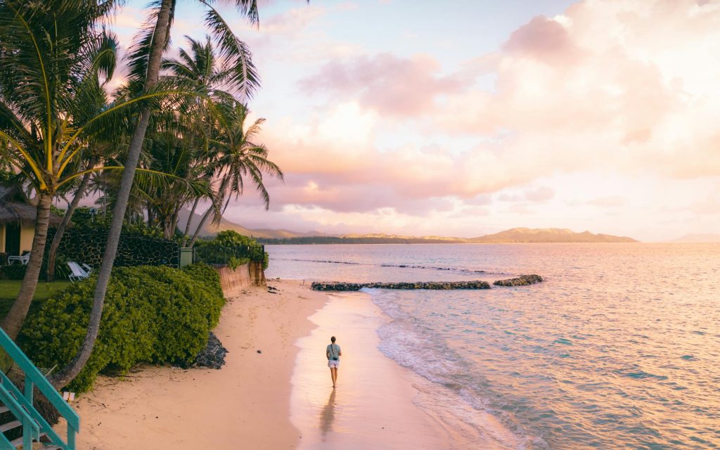 lady walking on beach in hawaii